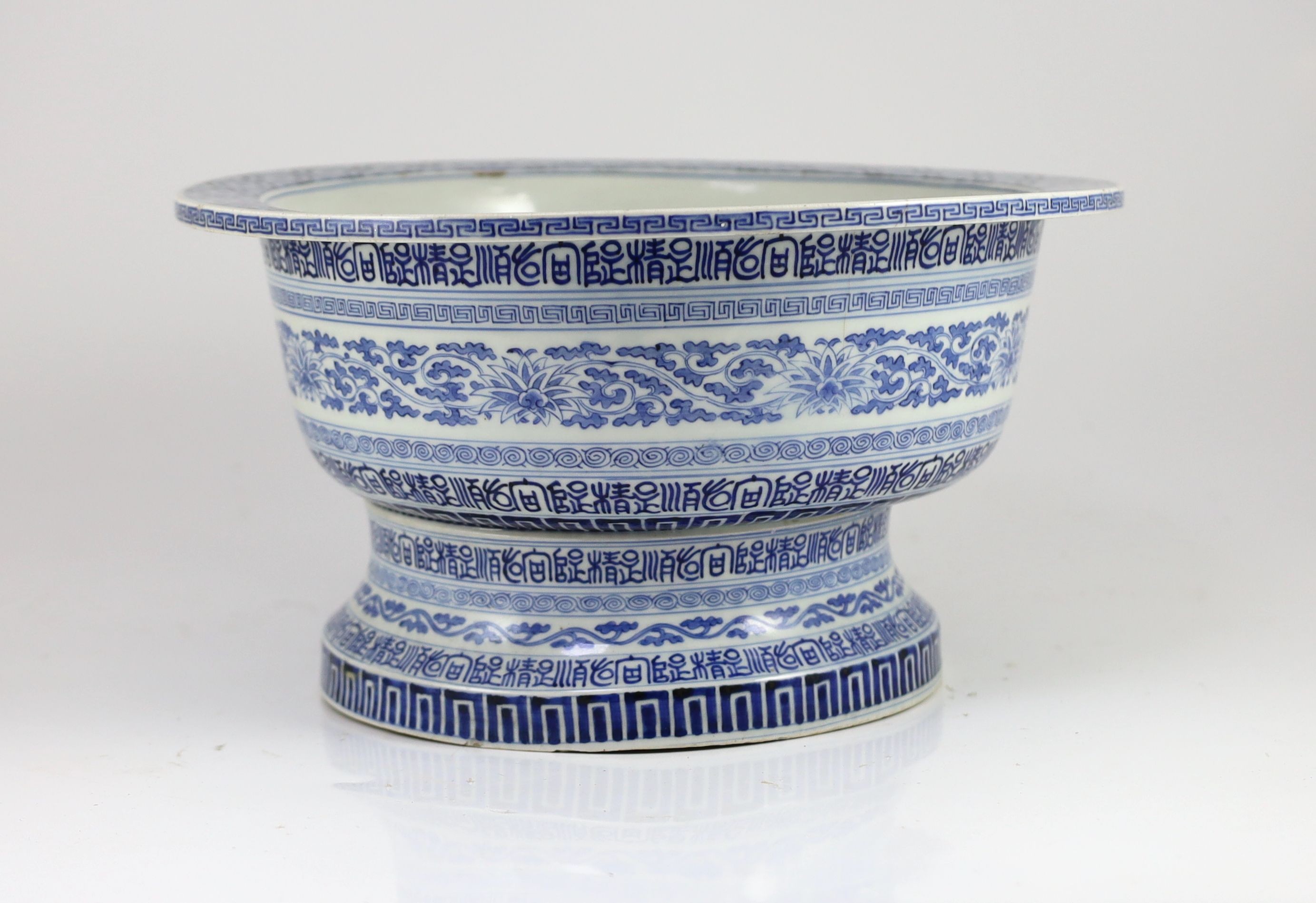 A unusual Chinese blue and white pedestal bowl or basin, 19th century, 34cm diameter, cracks